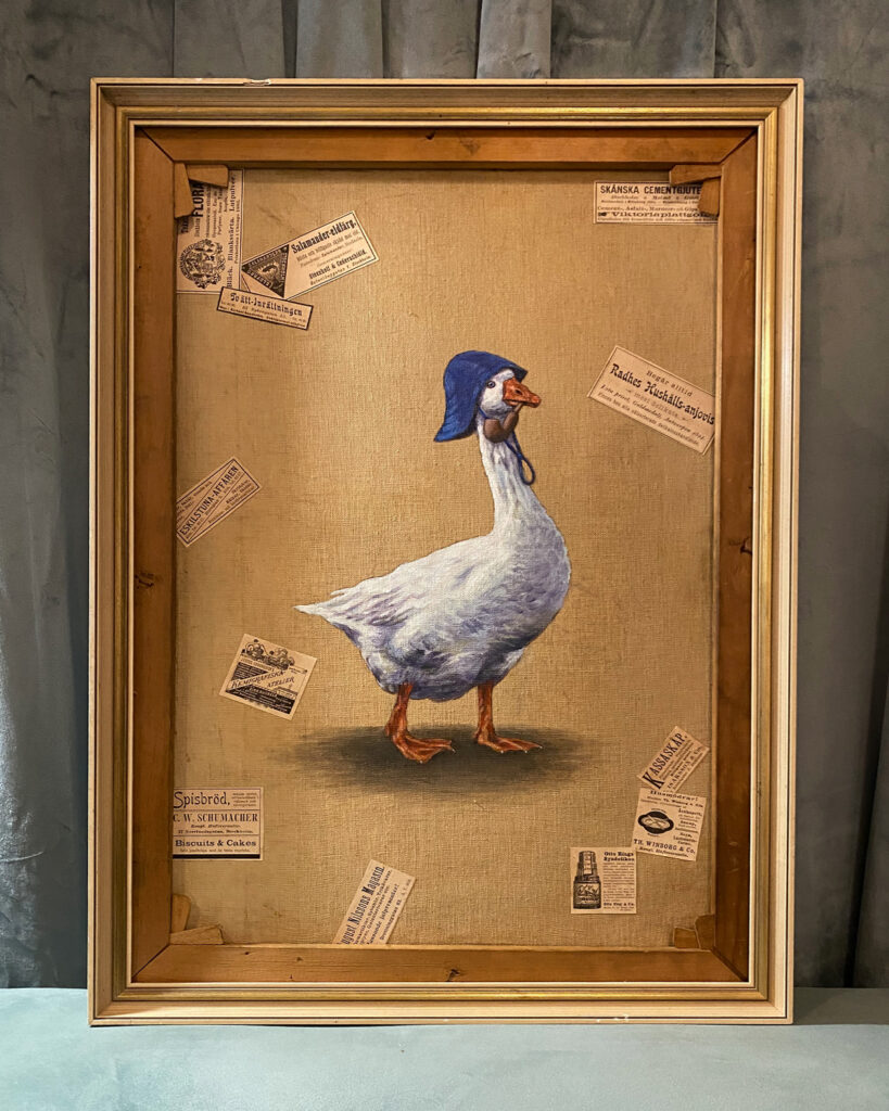 Goose in blue rainhat on the back of an old painting by Jenny Holmlund