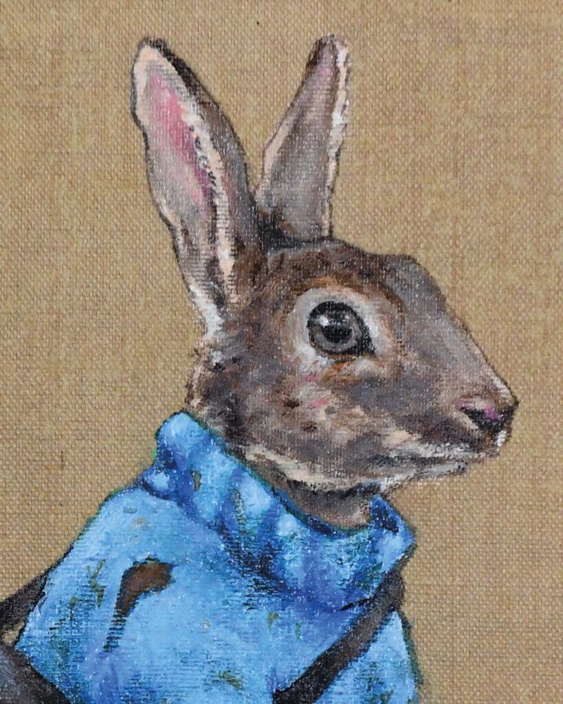 Close up of Painting of rabbit in a blue sweater by Jenny Holmlund