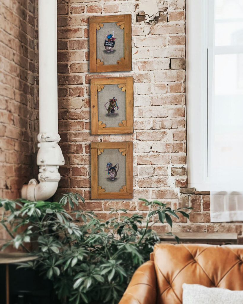 The 3 paintings in the series Rouge rodents made on the back of old paintings by Jenny Holmlund. Shown hanging on a brick wall.